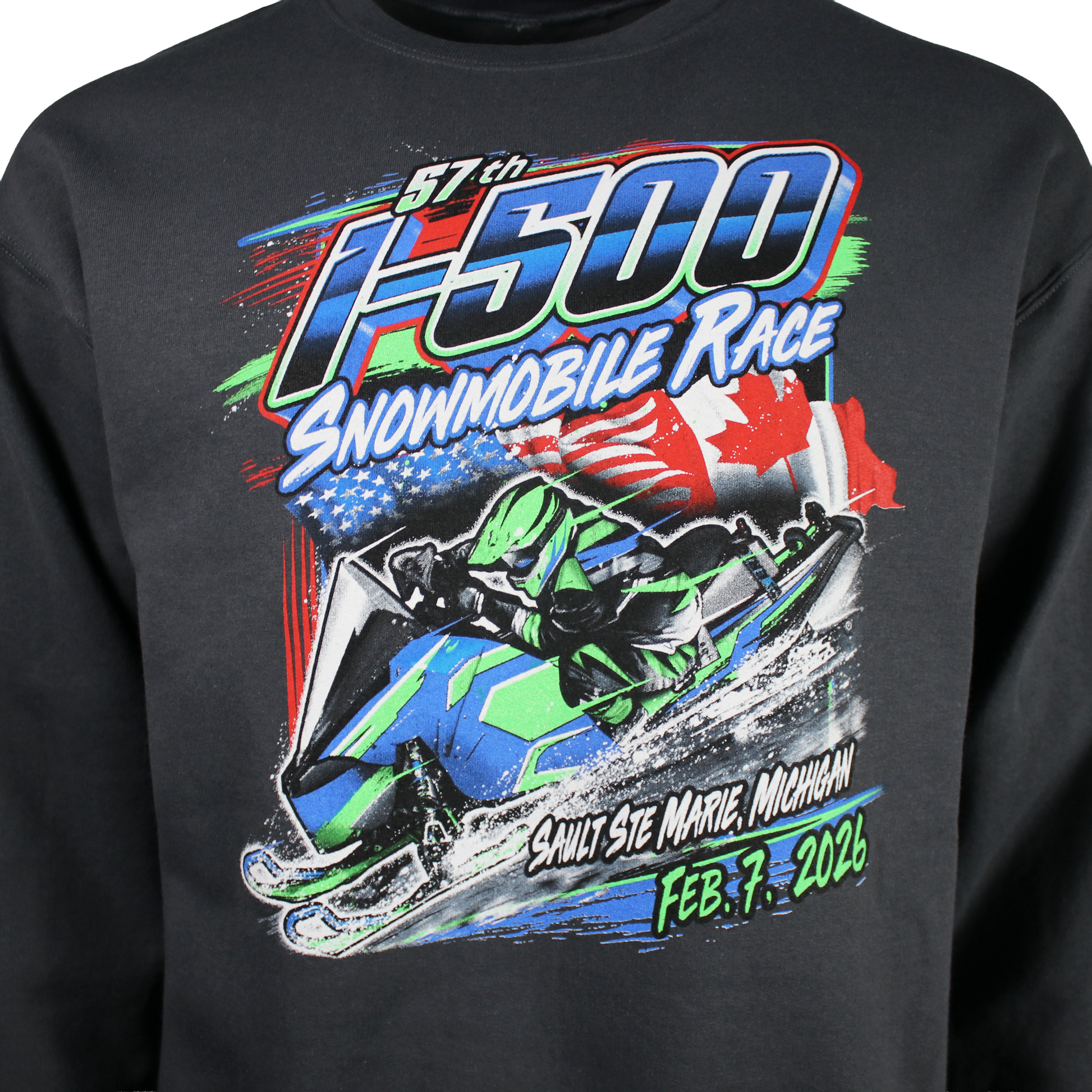 Close up of a snowmobile race graphic on the front of a sweatshirt with the text 'I-500 snowmobile Race, Sault Ste. Marie, Michigan, February 7th, 2026'.
