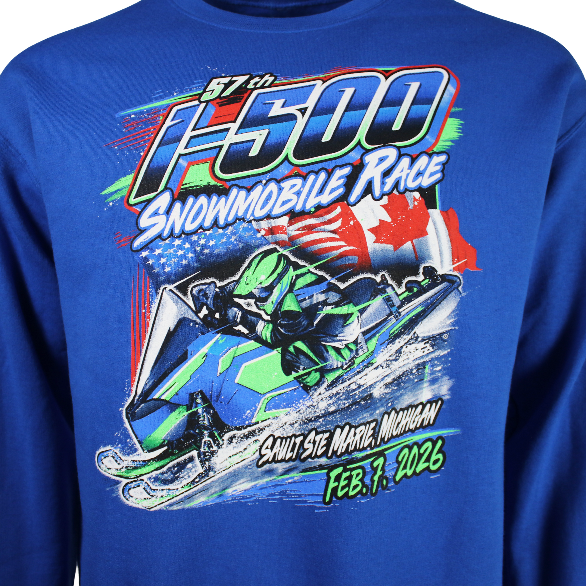 Close up of a snowmobile race graphic on the front of a blue sweatshirt with the text 'I-500 snowmobile Race, Sault Ste. Marie, Michigan, February 7th, 2026'.