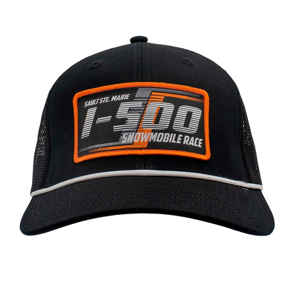 Front of a black cap with orange and grey I-500 patch on the front and a white rope across the bill.